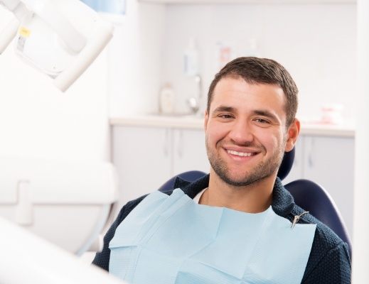 Smiling man sitting in sleep center treatment chair